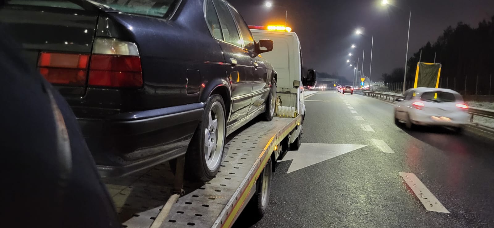 laweta transportująca nocą auto osobowe